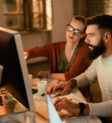 Young business colleagues using computer while working together in the office.